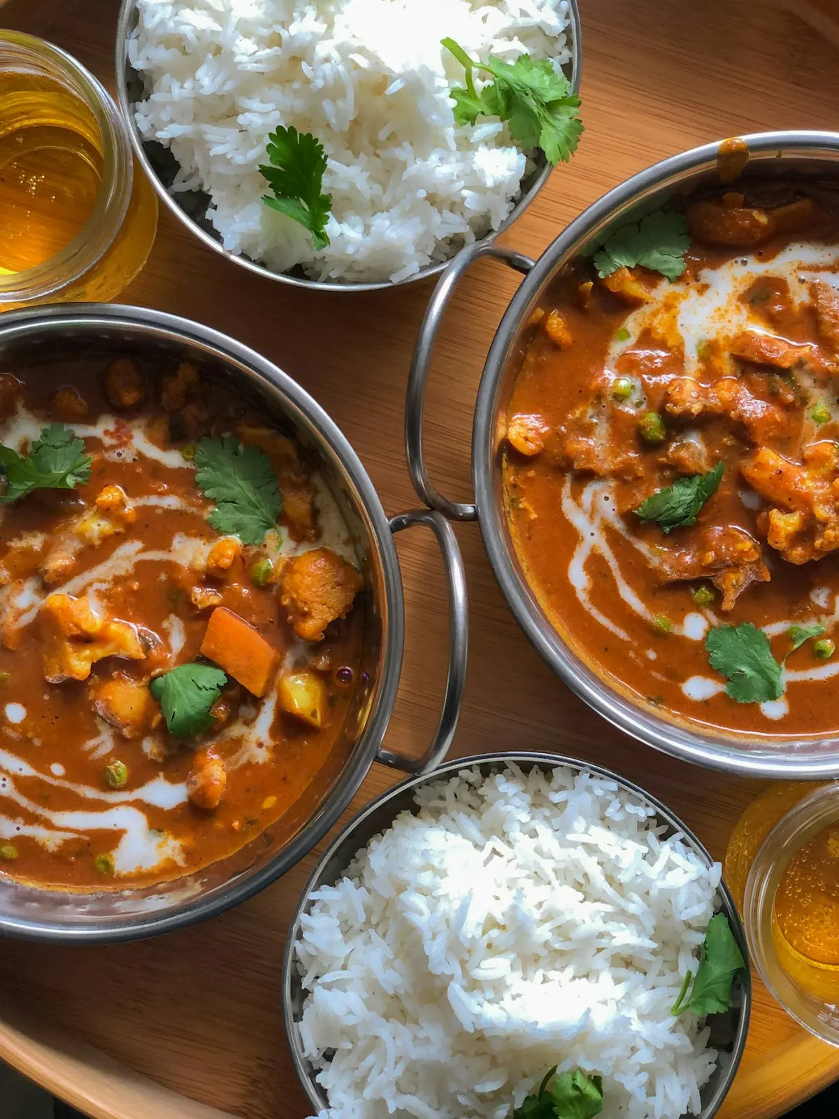 Indian curries with rice served in steel bowls